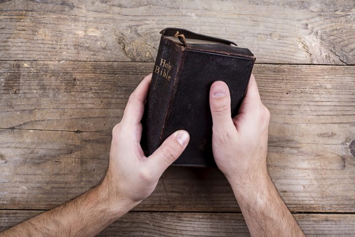 Bible and praying hands